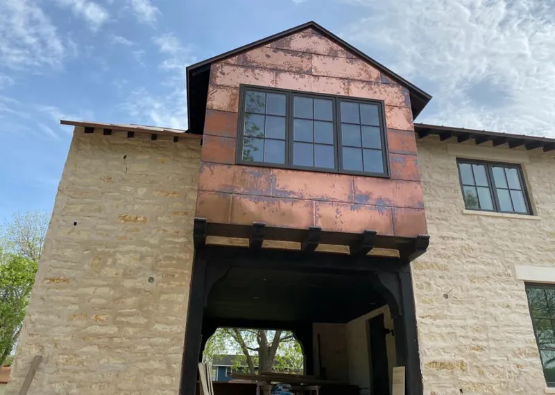Copper metal panel facade on a stone building for Skylight Installation in Camano