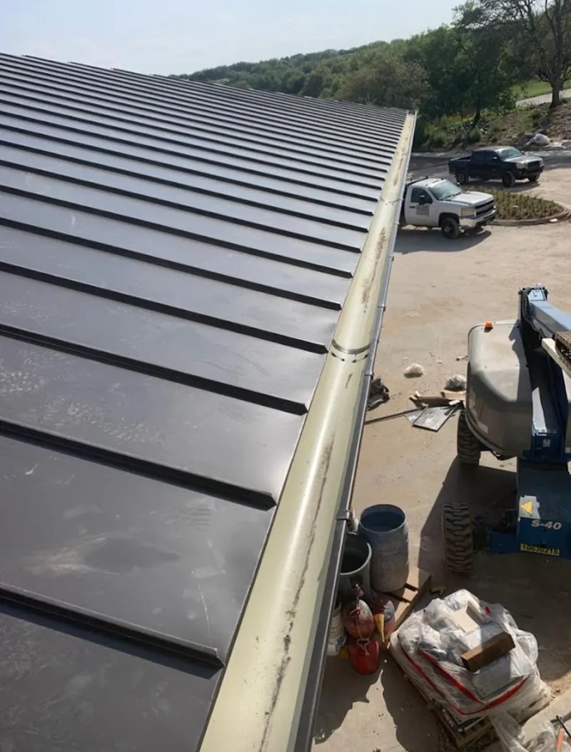 Standing seam panel and gutter detail on a metal roofing jobsite in Camano